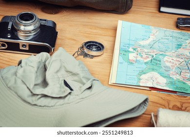 Vacation, map and compass with camera on table for itinerary schedule, adventure explore and direction. Vintage, photography and travel with holiday planning for tourism, navigation and discovery