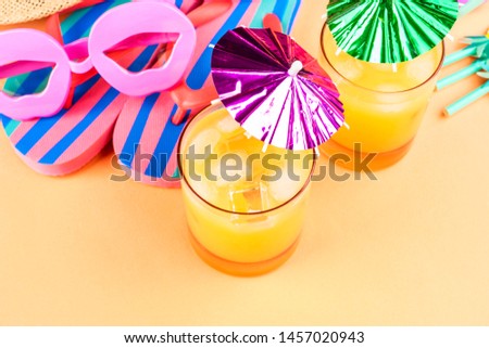 Vacation on the beach concept with colorful summer cocktails and beach accessories - hat, flip flops, sun glasses