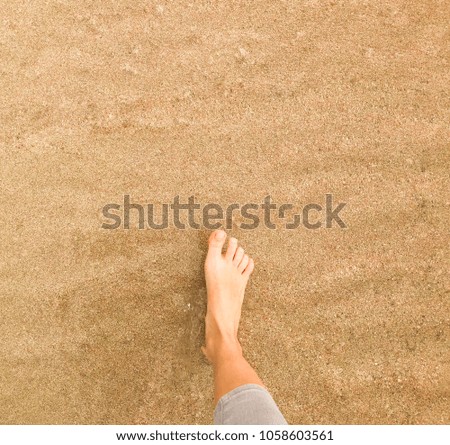 Vacation on ocean beach, female feet on sea sand