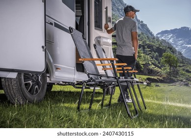 Vacation in a Recreational Vehicle. Caucasian RV Owner in Front of His Vehicle.