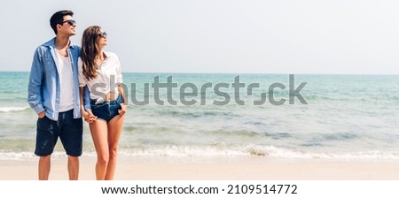 Vacation romantic love young happy smile couple in honeymoon travel holiday trip standing on sand at blue sky sea beach having fun and relaxing together on tropical beach.Summer travel