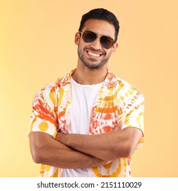 Its Vacation Time. Shot Of A Young Man Wearing Glasses And A Tie Dye Shirt While Standing Against A Yellow Background.