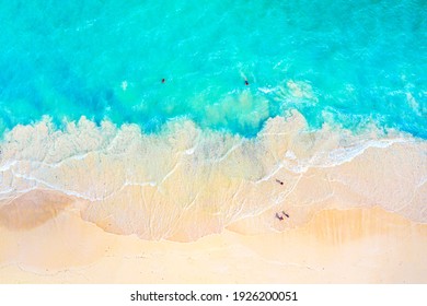 Vacation travel background. Top view aerial drone photo of ocean seashore with beautiful turquoise water and foam sea waves. Caribbean resort