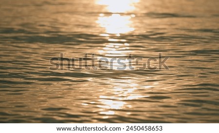 Vacation And Travel Concept. Water Surface Reflects Evening Sun. Abstract Natural Background.