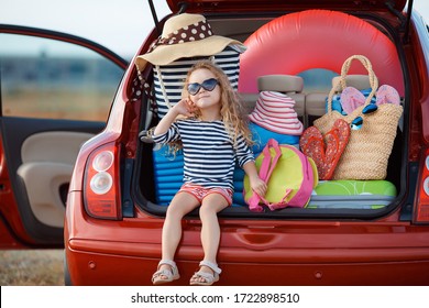 Vacation, Travel - Family Ready For The Travel For Summer Vacation; Suitcases And Car With Sea On Background; Girl With Map In Hands Planning Road Trip; Travel Concept; Traveler