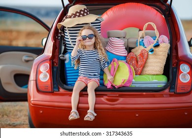 Vacation, Travel - Family Ready For The Travel For Summer Vacation. Suitcases And Car With Sea On Background. Girl With Map In Hands Planning Road Trip. Travel Concept. Traveler.