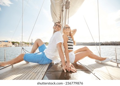 vacation, travel, sea, friendship and people concept - smiling couple sitting and talking on yacht deck