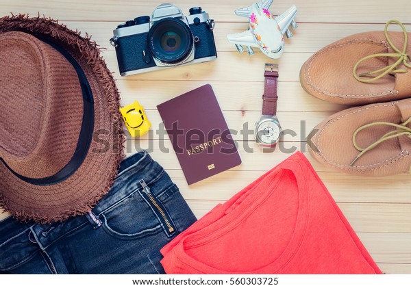 vacation, travel, tourism, technology and objects\
concept - Top view of gadgets and traveler personal stuff lay on\
Wooden ground.