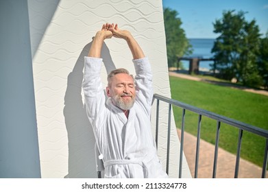 Vacationer In A White Terry Bathrobe Basking In The Sunshine