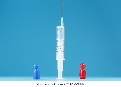 Vaccinate Or Refuse A Syringe With A Vaccine With Two Groups Of People A Red And A Blue Human Model. The Concept Of Distrust And The Dangers Of The Vaccine