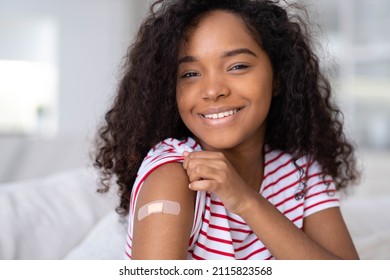 Vaccinated African American Woman Showing Arm With Medical Plaster Patch Plaster On Shoulder, Black Female After Getting Vaccine Dose Against Covid. Healthcare Immunization, Coronavirus Vaccination