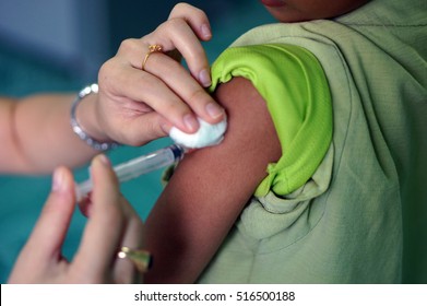 Vaccinating A Child,Injection with a syringe to prevent flu. - Shutterstock ID 516500188