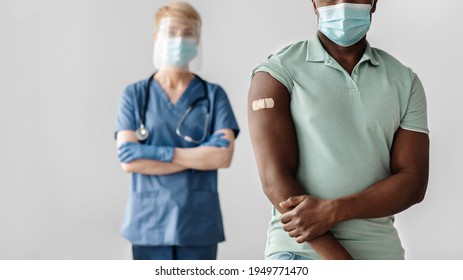 Vaccination Campaign, Ad, New Normal And Health Care During Covid-19. Adult Female Nurse In Protective Mask With African American Patient With Band Aid On Arm After Injection, Panorama, Cropped