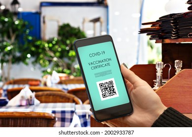 Vaccination Certificate,vaccine Passport Digital Application Of Covid Vaccine For For For Visiting Restaurants And Public Places, Hand With Smartphone And Qr Code In City Cafe