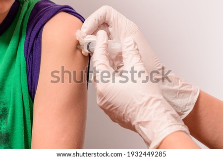 Vaccination of a child to develop immunity to the disease, the introduction of the vaccine into the hand, the child's hand and the hands of the laboratory assistant. new