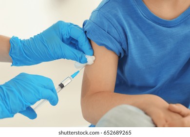 Vaccination concept. Female doctor vaccinating cute little boy in clinic, closeup