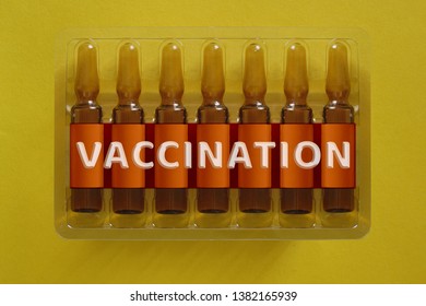 Vaccination concept. Seven ampules with overlay letters of inscription V A C C I N A T I O N. Vaccine biotechnology banner
