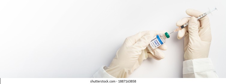 Vaccination Development For Covid-19 Pandemic. Doctor's Hands In Medical Latex Gloves Takes Shot From Coronavirus Vaccine Vial By Sterile Needle Syringe. Hope, Success, COVAX, Collaboration Concept.