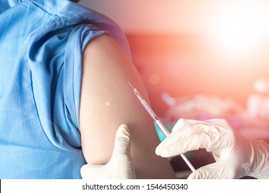 
Vaccination Healthcare Concept. Hands Of Doctor Or Nurse In Medical Gloves Injecting A Flu Shot Of Vaccine To A Man Patient. 