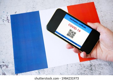 Vaccination Passport In Hands Allowing Movement And Travel In France. Vaccination Against The Coronavirus Covid -19. Imunity Passport. Health Passport. Top View, Closeup