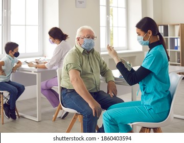 Vaccination For People Of Different Ages. Asian Doctor Giving Flu Or Pneumonia Shot To Senior Man In Face Mask. Elderly Patient, Being In Risk Group, Receiving Covid-19 Vaccine In Modern Clinic Office