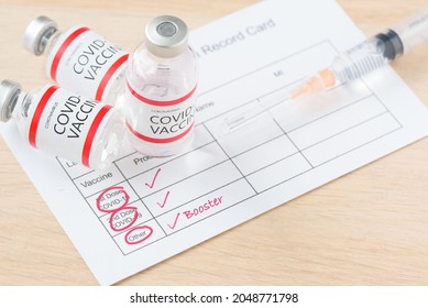 Vaccination record card showing booster dose of covid-19 vaccine. The third vaccination for immunity against delta variant and omicron variant.