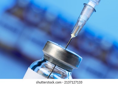 Vaccine bottle with a syringe taking the vaccine from it - Powered by Shutterstock