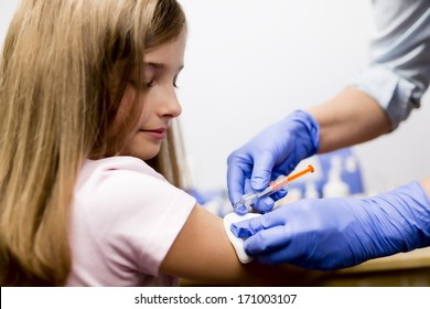 Vaccine - a doctor giving vaccination girl, health, prevention