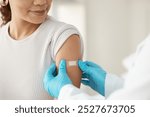 Vaccine, happy woman and hands of doctor with plaster for health, wellness and service in clinic. Healthcare, patient and expert in hospital for immune system strength, illness prevention or flu shot