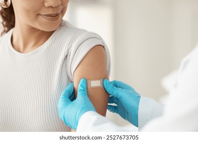 Vaccine, happy woman and hands of doctor with plaster for health, wellness and service in clinic. Healthcare, patient and expert in hospital for immune system strength, illness prevention or flu shot