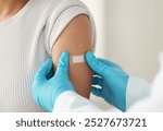 Vaccine, person and hands of doctor with plaster for health, wellness and injection in clinic. Healthcare, patient or specialist in hospital for immune system strength, illness prevention or flu shot