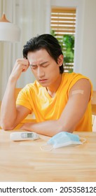 Vaccine Side Effect Concept - Asian Man Gets Vaccinated For COVID19 And He Has Headache At Home