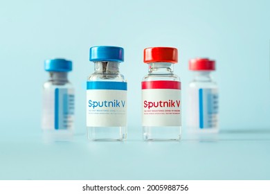 The Vaccine Sputnik V From The Coronovirus Infection Covid 19 On A Blue Background And A Syringe On The Table. January 18, 2021, Barnaul, Russia.