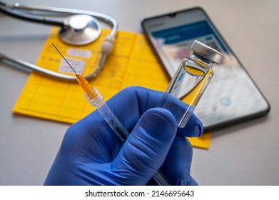 Vaccine With Syringe And Vaccination Card In A Doctor's Office