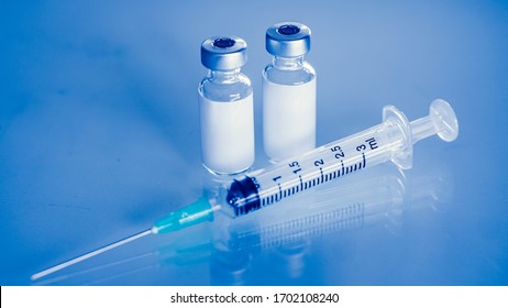 Vaccine vial dose flu shot drug needle syringe,medical concept . blue background. selection focus.