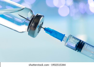 Vaccine Vial Dose Flu Shot Drug Needle Syringe On Blue Background. Medical Concept Vaccination Hypodermic Injection Treatment Disease Care Hospital Prevention Immunization Illness Disease Baby Child