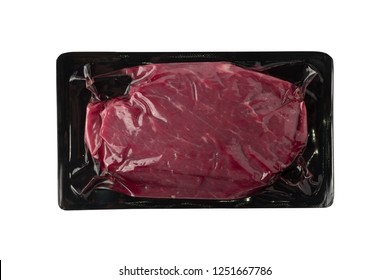 Vacuum Black Plastic Pack With Fresh Beef Steak Isolated On White Background. Raw Meat Packed Without Label Top View