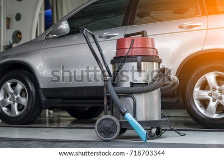 vacuum cleaner at carcare or auto washing service station with sunlight effect