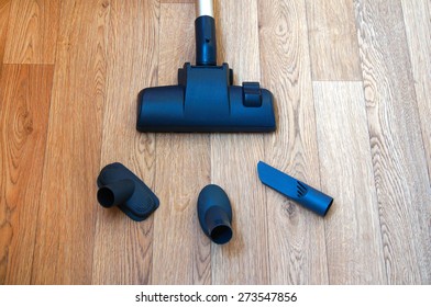 Vacuum Cleaner Nozzle And Three On The Wooden Floor