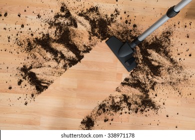 Vacuum Cleaning Hardwood Floor In Living Room