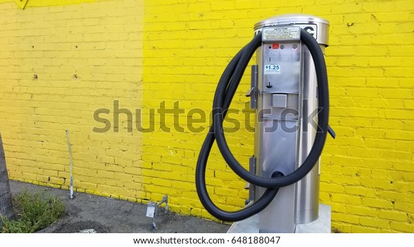 vacuum\
machine for car, yelllow wall as a\
background