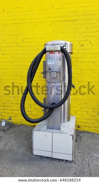 vacuum\
machine for car, yelllow wall as a\
background