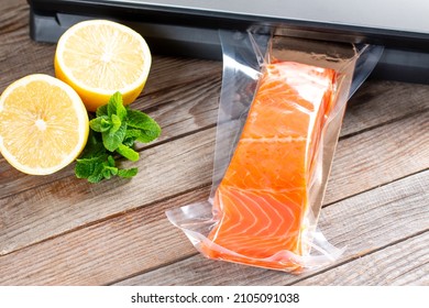 Vacuum seal packing machine for keep all food longer life. Salmon fillets in a vacuum package - Shutterstock ID 2105091038