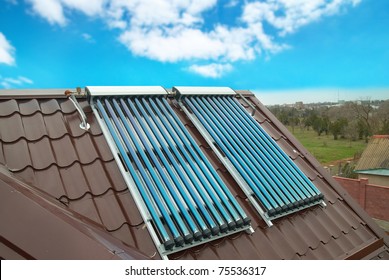 Vacuum Solar Water Heating System On The House Roof.