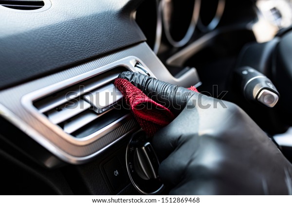 Vacuuming the car, cleaning the interior of the car\
with a microfiber\
cloth