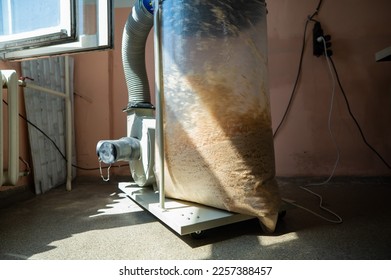 Vacuuming sawdust while sawing wood. Chip blower in furniture production.  - Powered by Shutterstock