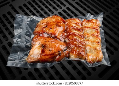 Vacuum-packed grilled meat, on a dark background. Set of different types of meat. Ready to eat.