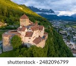 Vaduz Castle in Liechtenstein. Picturesque view of fairytale castle in Alps mountains at Sunset Time. A Landmark Aerial