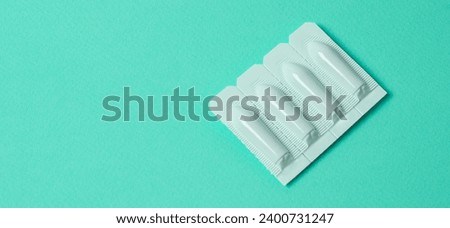 vaginal suppositories on mint background. Top view. Treatment of vaginal infections from sexually transmitted infections. Woman health. Contraception, birth control. Planning pregnancy