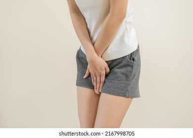 Vaginal, Urinary Incontinence. Pain Asian Young Woman Hand Holding Crotch Suffering From Pain ,itchy Or Scratch Of Vagina, Genital Itching From Infection. Gynecological Problems Menstrual Disorder